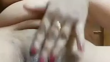 Chubby, young lady enjoys fingering her shaved pussy