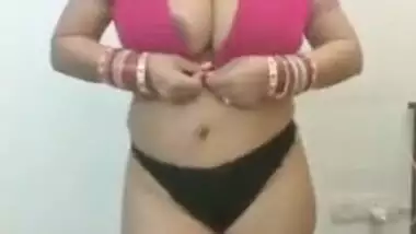 Full-bosomed Indian MILF unbuttons red bra to show her porn pomelos