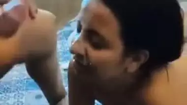 A girl gets cum on her face in an Indian threesome blue film