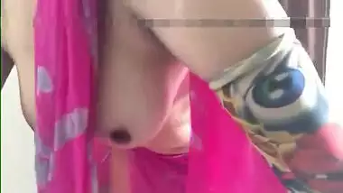 Defenseless Indian girl in a pink sari airs her sex melons in XXX video